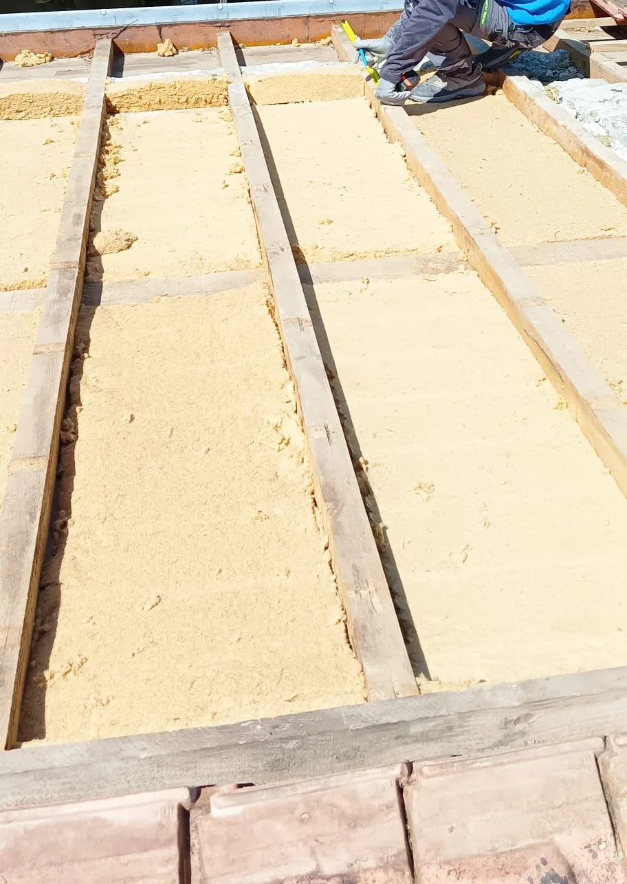 Panneaux isolants posés entre les chevrons d'une toiture découverte